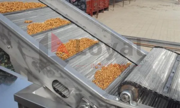 Continuous fryer with hood and belt lifted for cleaning access